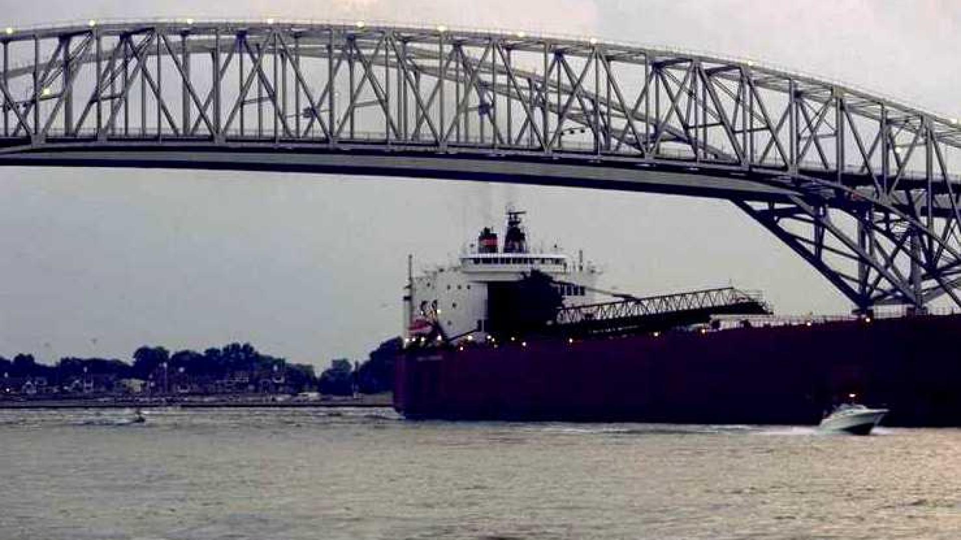 Cargo ship going under the bridge. 