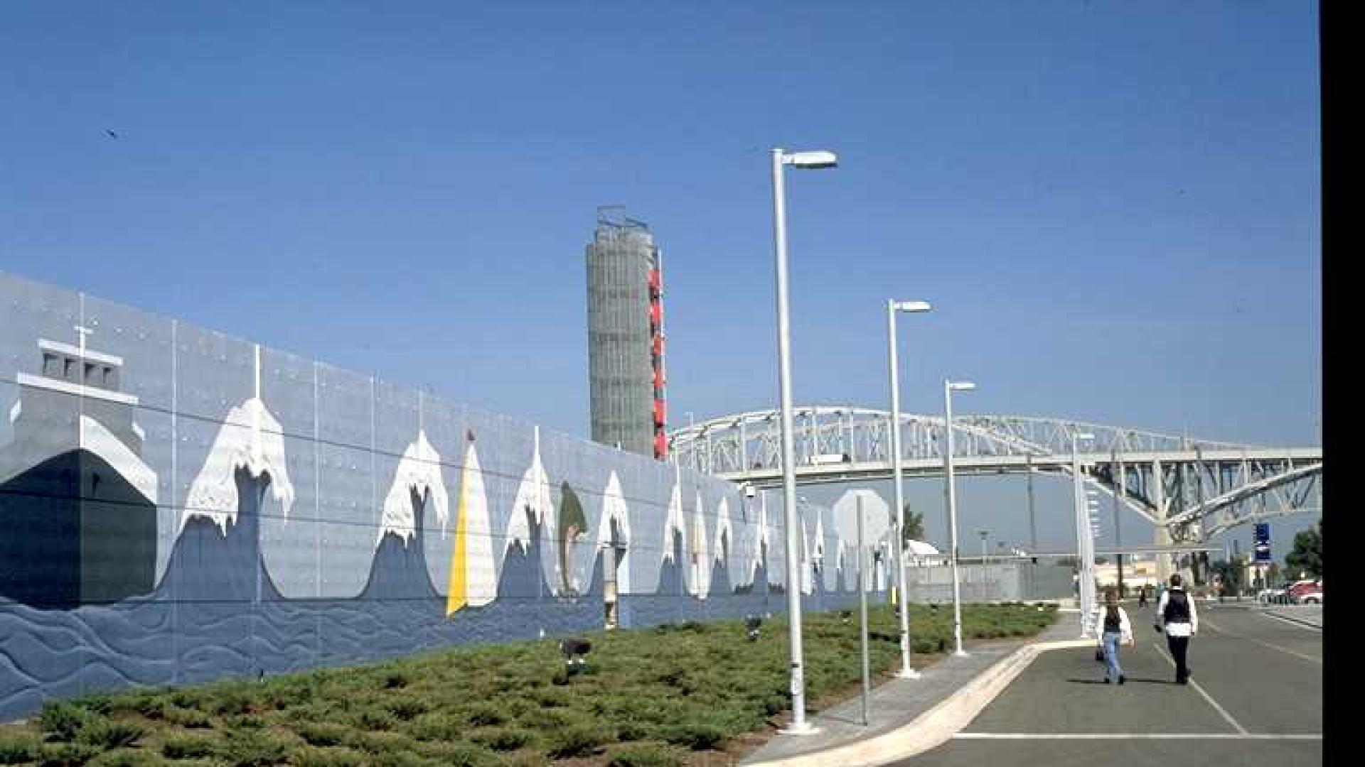 Mural of boat and waves. A bridge stands tall in the background