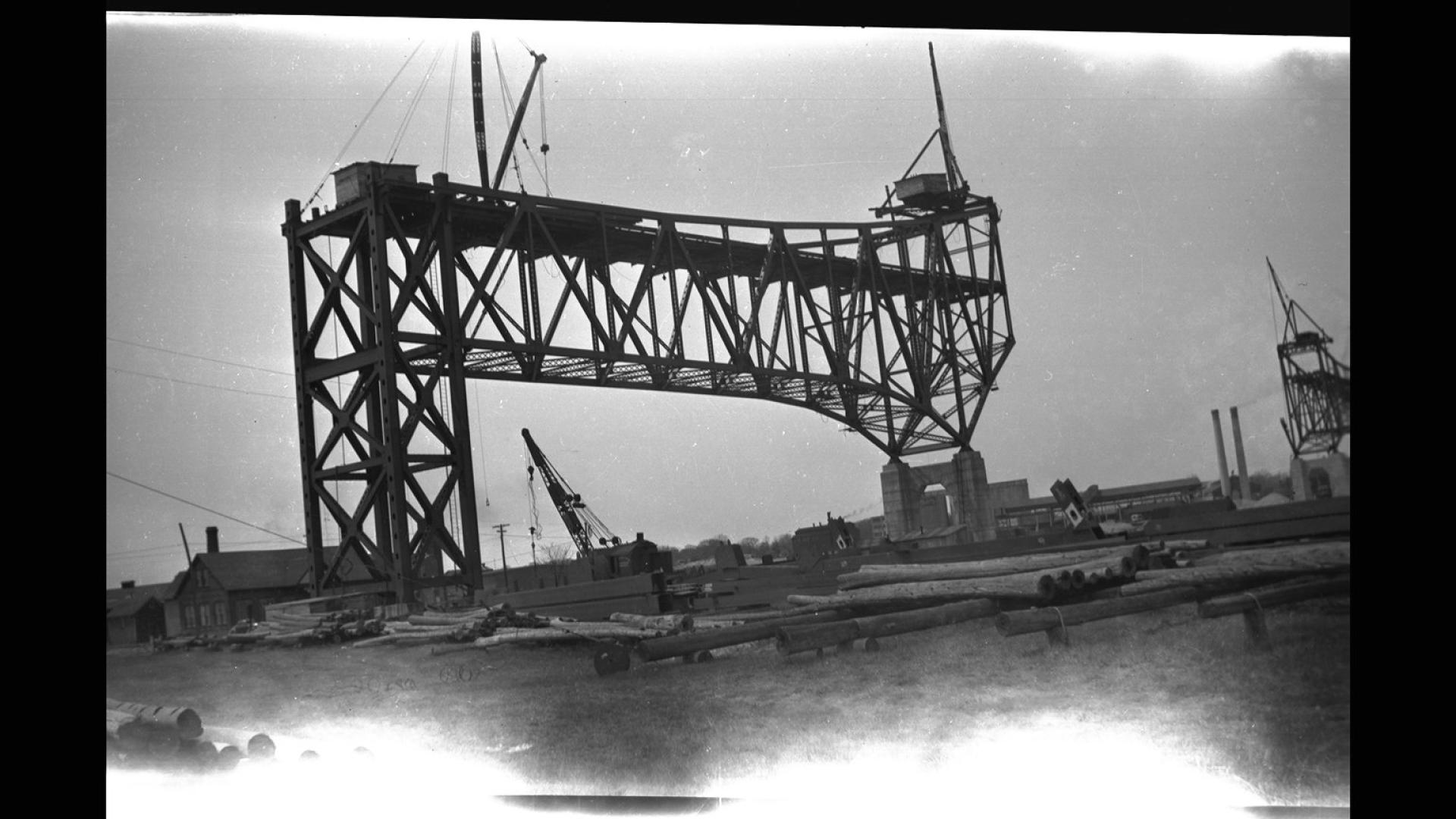 Section of bridge being built. The image is heavily faded at the bottom.