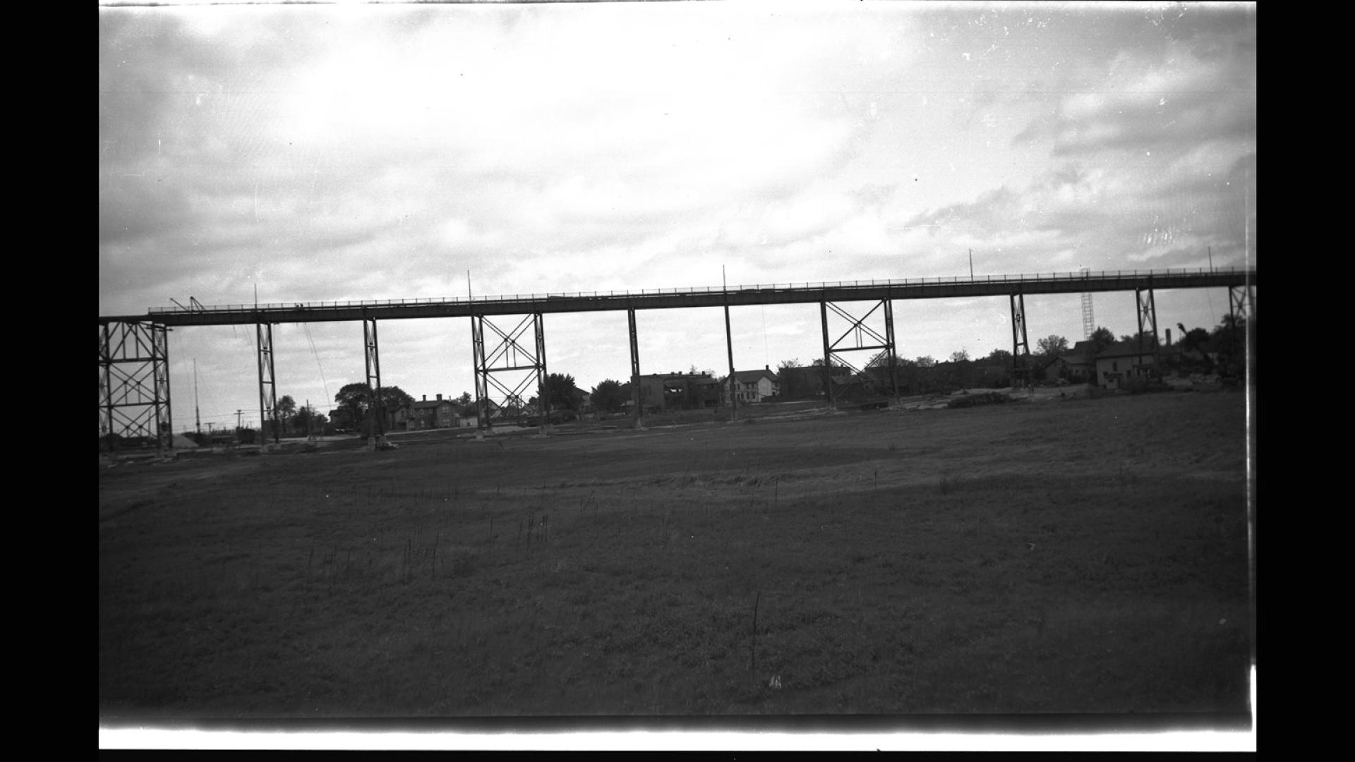 Silhouette of bridge. There are clouds in the background. 