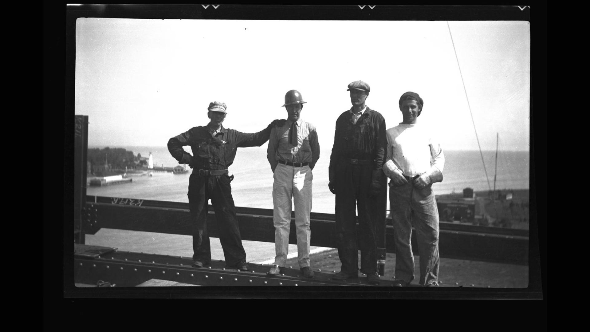 Group of four men posing for a photograph.