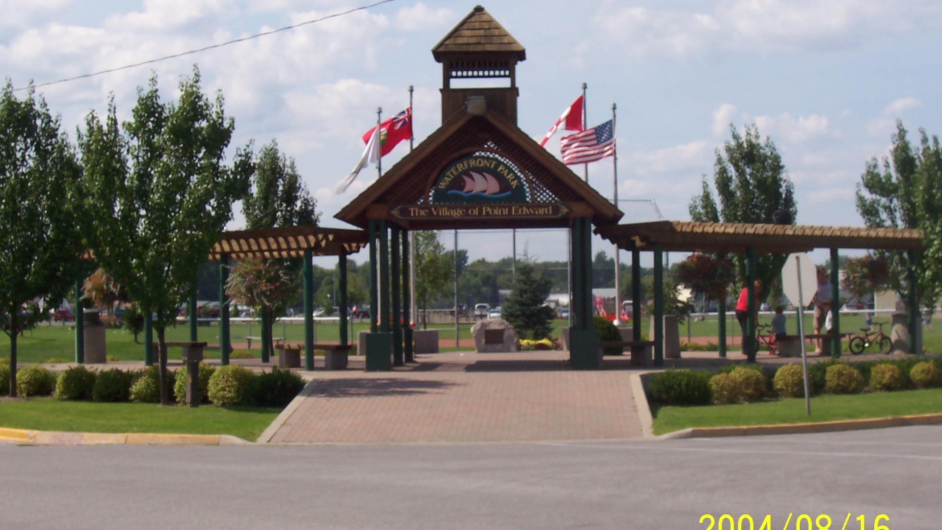 Waterfron park entrance for Point Edward. There are flags flying on flagpole in the background.