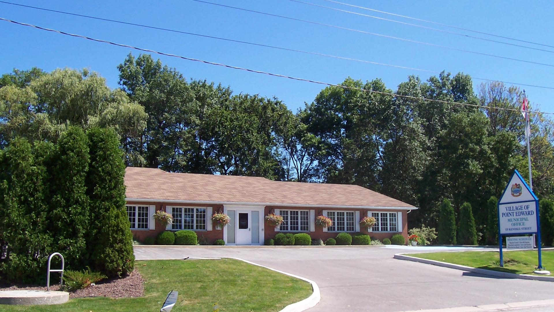 Building in the background with a large driveway in the foreground.